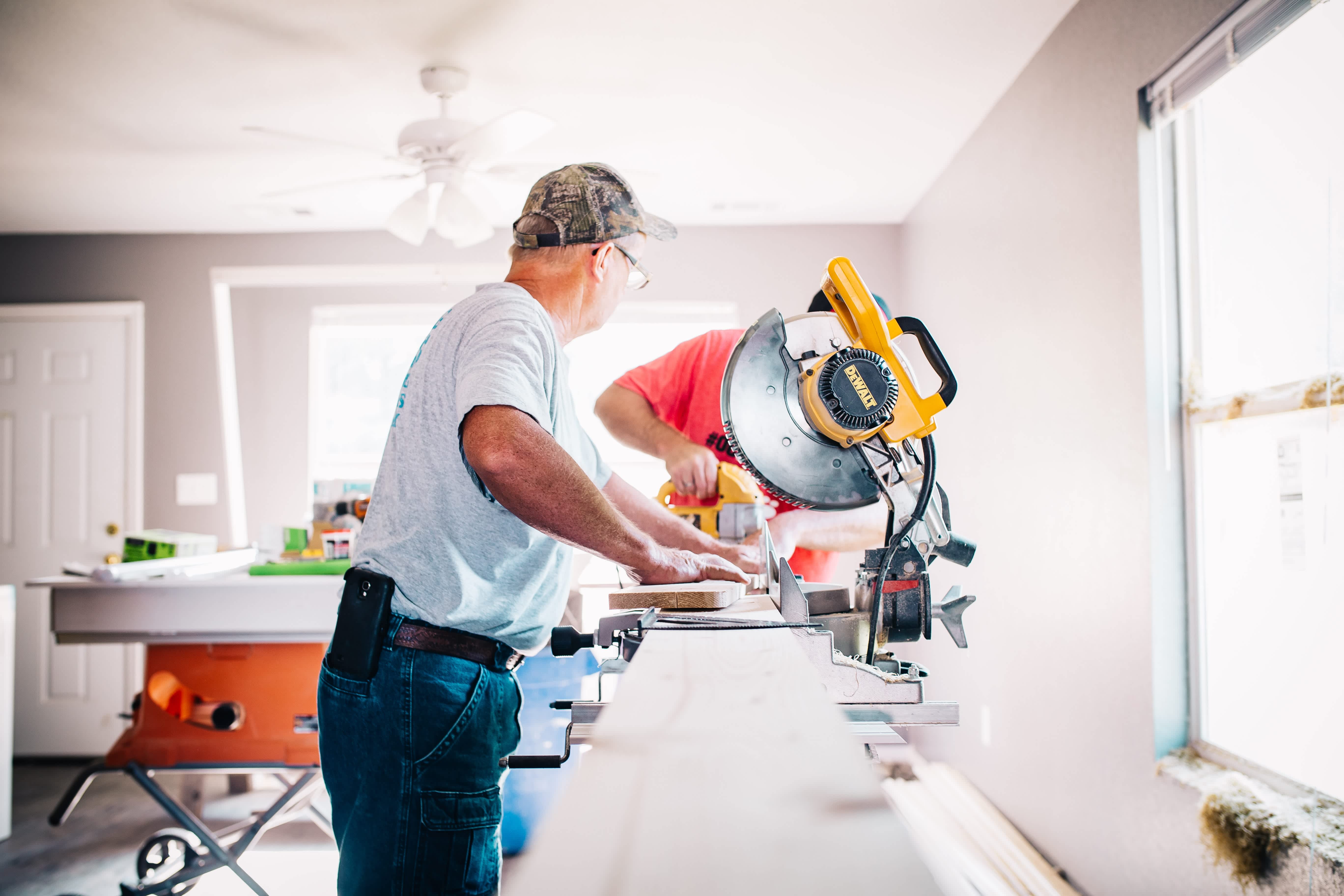 Person using saw in home.